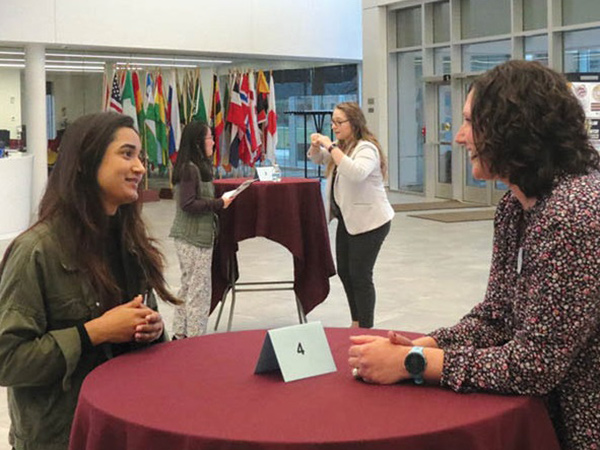 Student interacting with networking participant