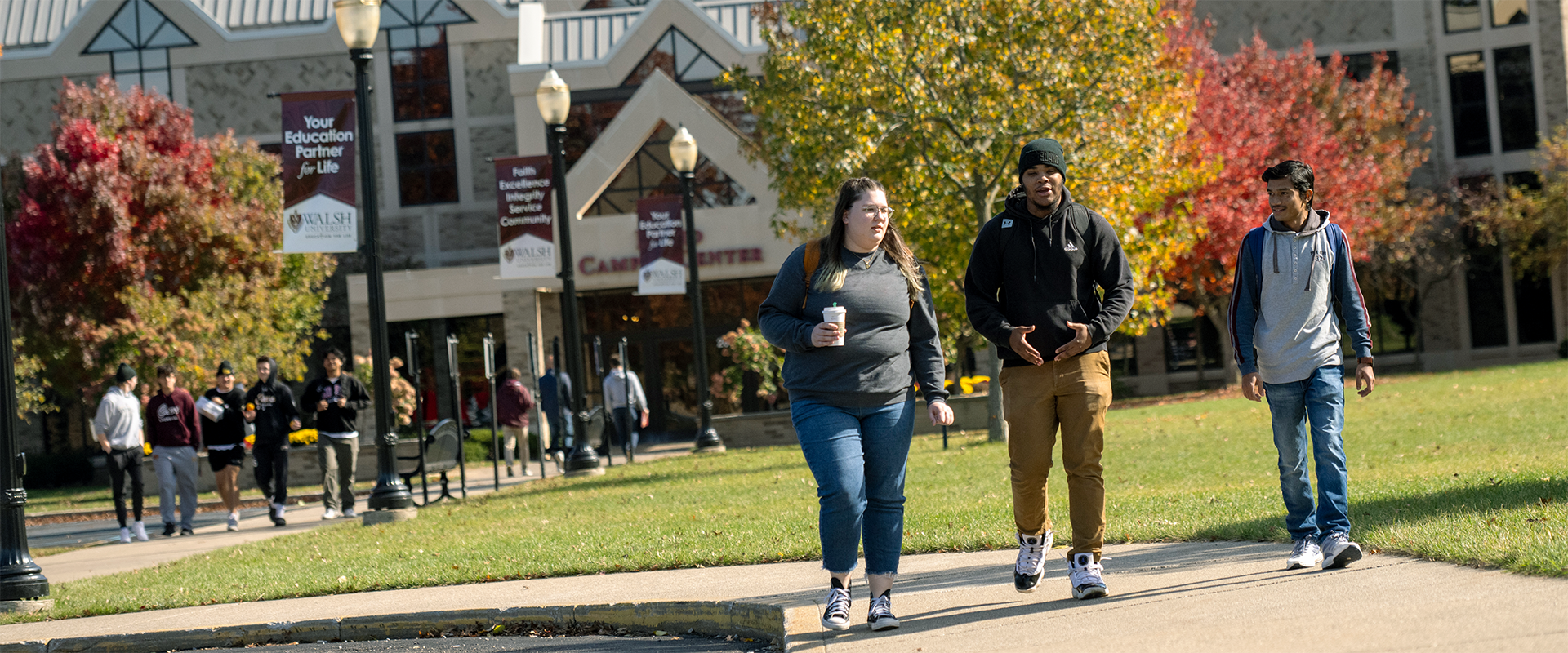 photo of three students walking on campus