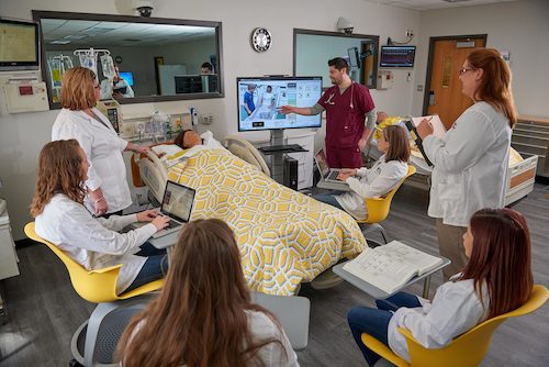 photo of a nursing class during a session in our simulation lab