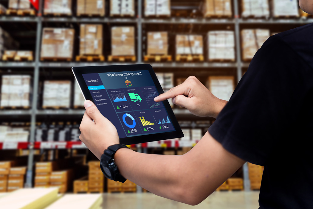 photo of a person in a warehouse operating a tablet