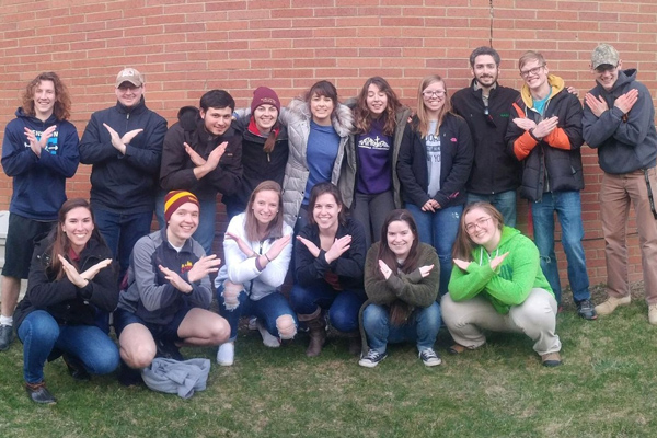 photo: Campus Ministry Cavs for Life group shot displaying Swords Up hand gesture