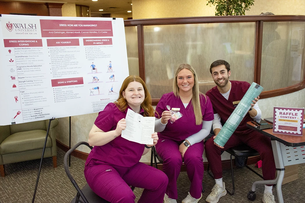 Walsh University students promoting stress management techniques at a wellness event, featuring a raffle contest.