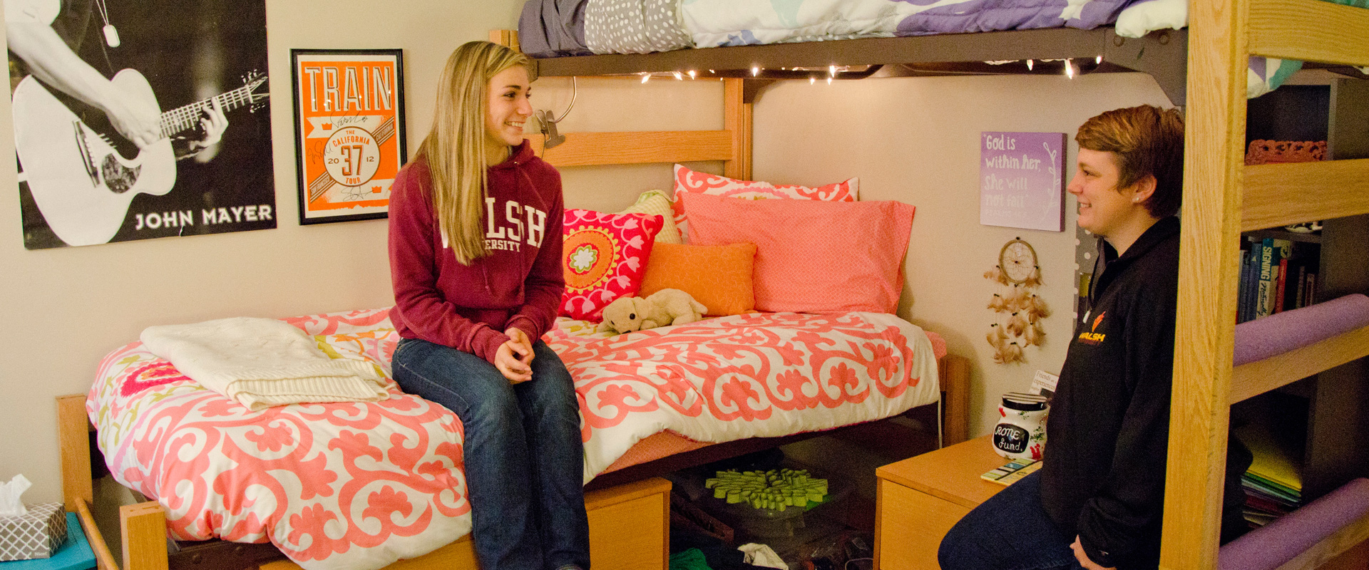 photo of two students conversing in a dorm room