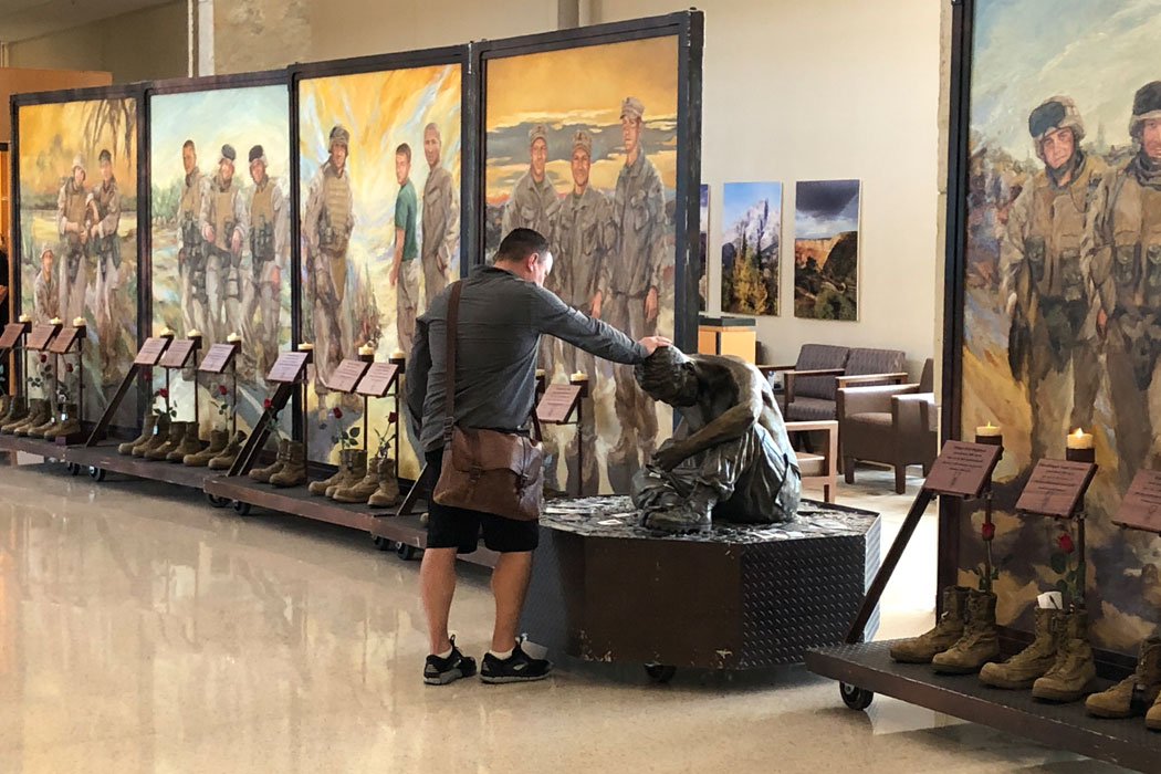 A man visits the Eyes of Freedom art display.