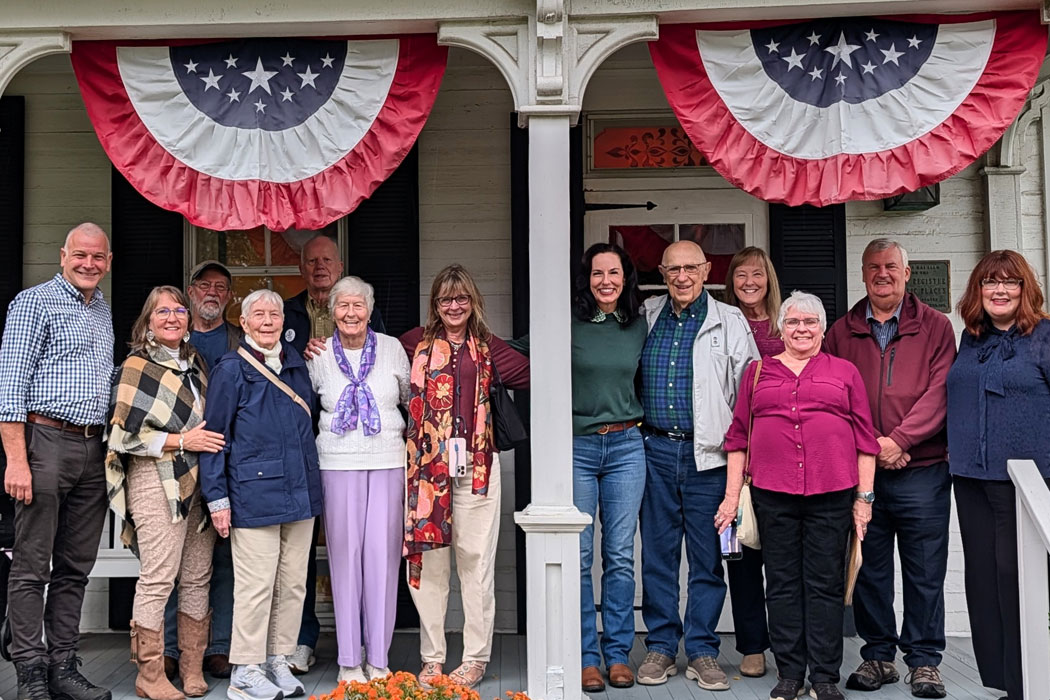 Reunited families stand on the porch of the Hoover Historical Center in North Canton, OH. 