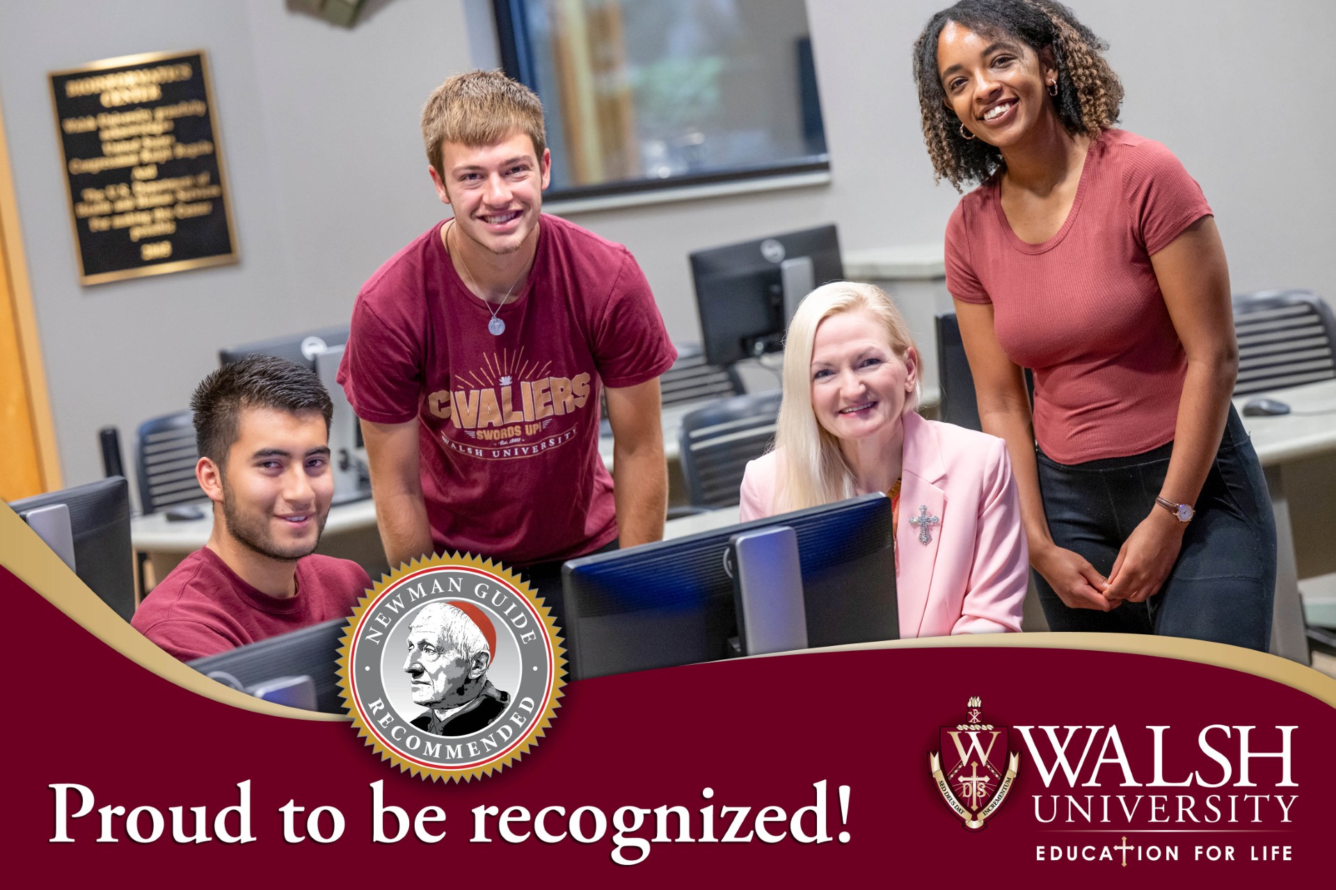 Students smile at the camera while sitting behing computers with a Walsh University professor. Prout to be Recognized is displayed in recognition of Walsh University being recognized in the 2026-27 Cardinal Newman Guide to Choosing a Catholic College