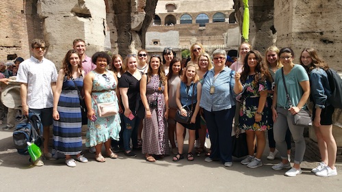 photo of a group of students at the Coliseum in Rome