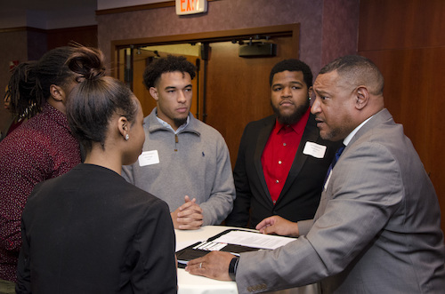 photo of students interacting with a professional mentor
